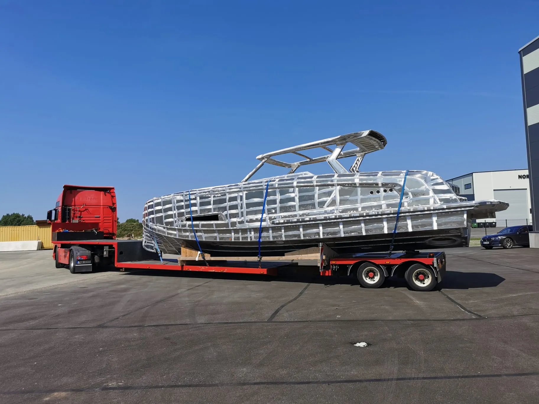 Aluminum hull on a low-loader on a sunny day.