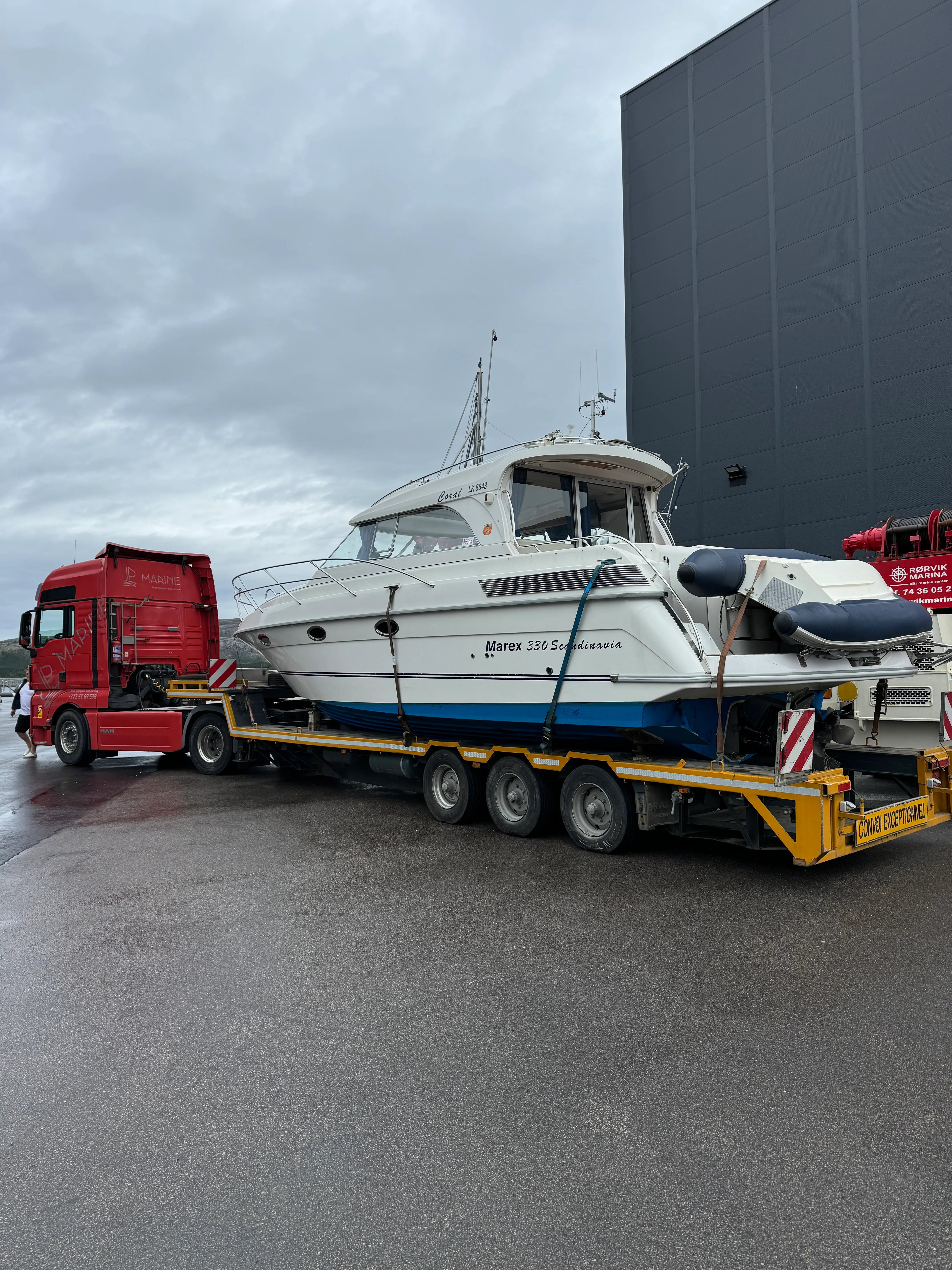 Yacht being lifted onto a low-loader trailer.
